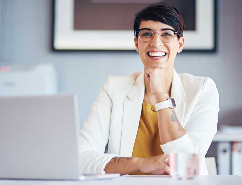 Image of a woman working in front of a laptop, featuring A+ Revenue Cycle Training and highlighting CPC training courses for medical coding professionals.