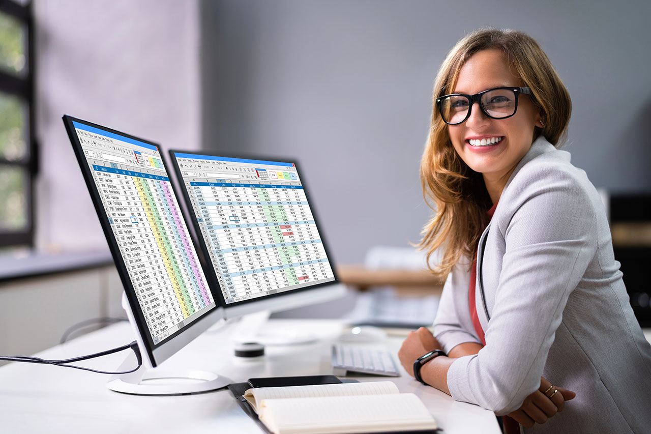 Image of a woman working in front of a laptop, featuring A+ Revenue Cycle Training and highlighting healthcare business solutions.